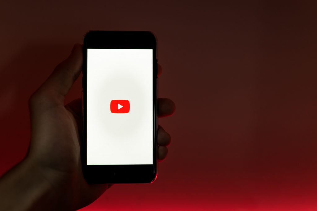 A photo of a phone displaying the YouTube logo